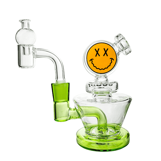 A three-quarter view of the Big Face Mini Rig 4-Piece Kit, a clear glass rig with a unique face-shaped design and visible joint.