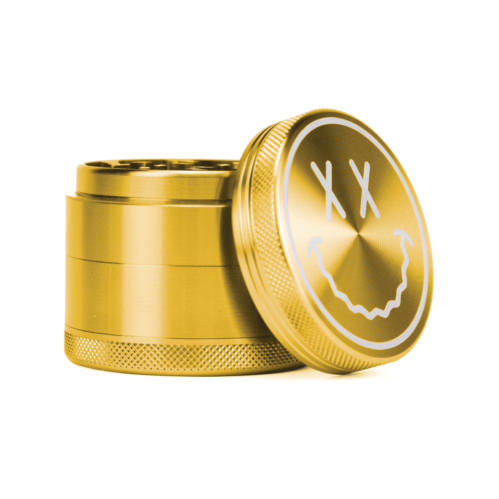 A top-down view of the open Goody Big Face Travel Size Grinder, showcasing its gold metallic finish and circular design.
