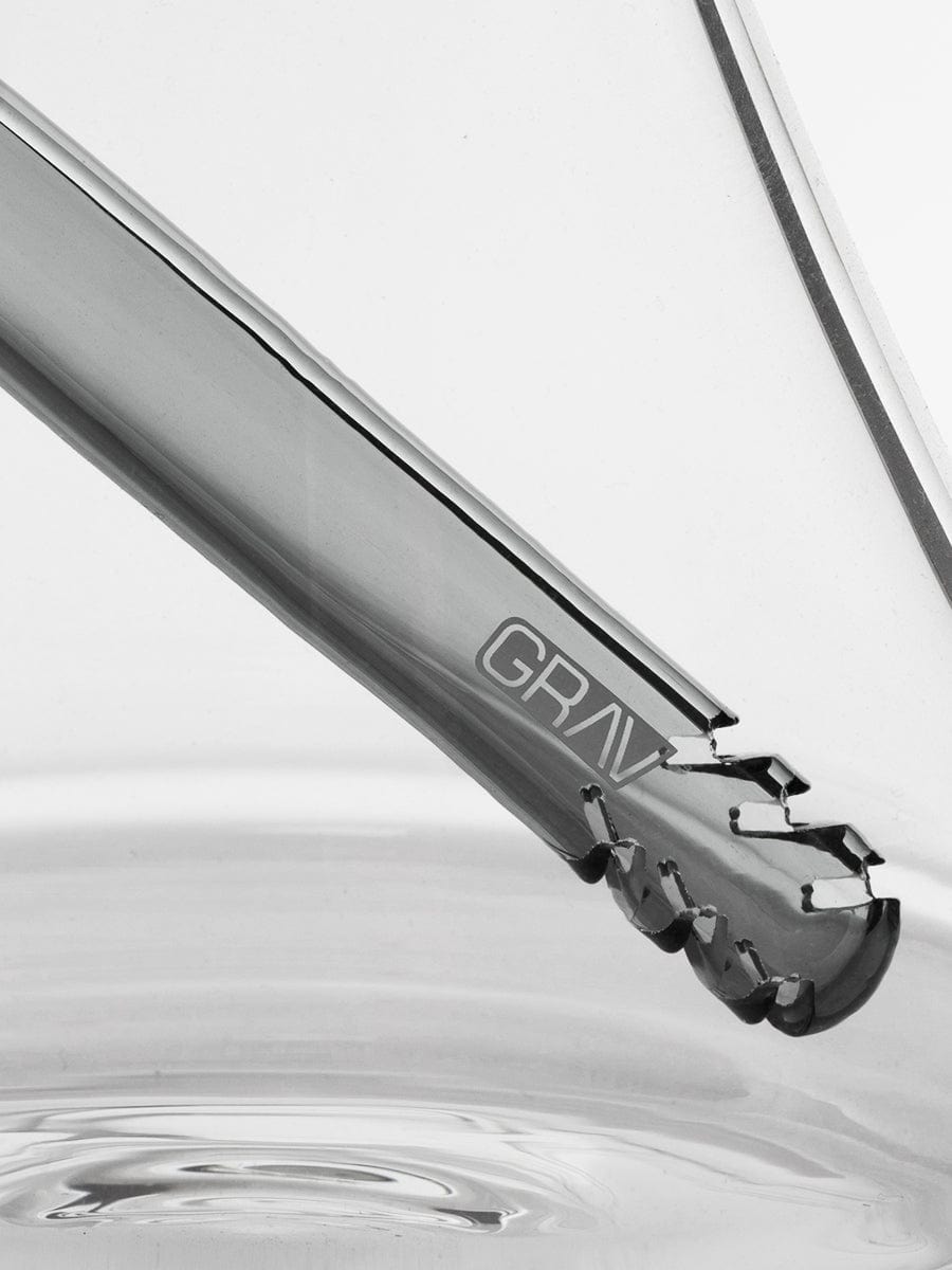 A close-up, angled view showcases the Medium Accented Deco Beaker Bong with a smooth, clear glass construction.