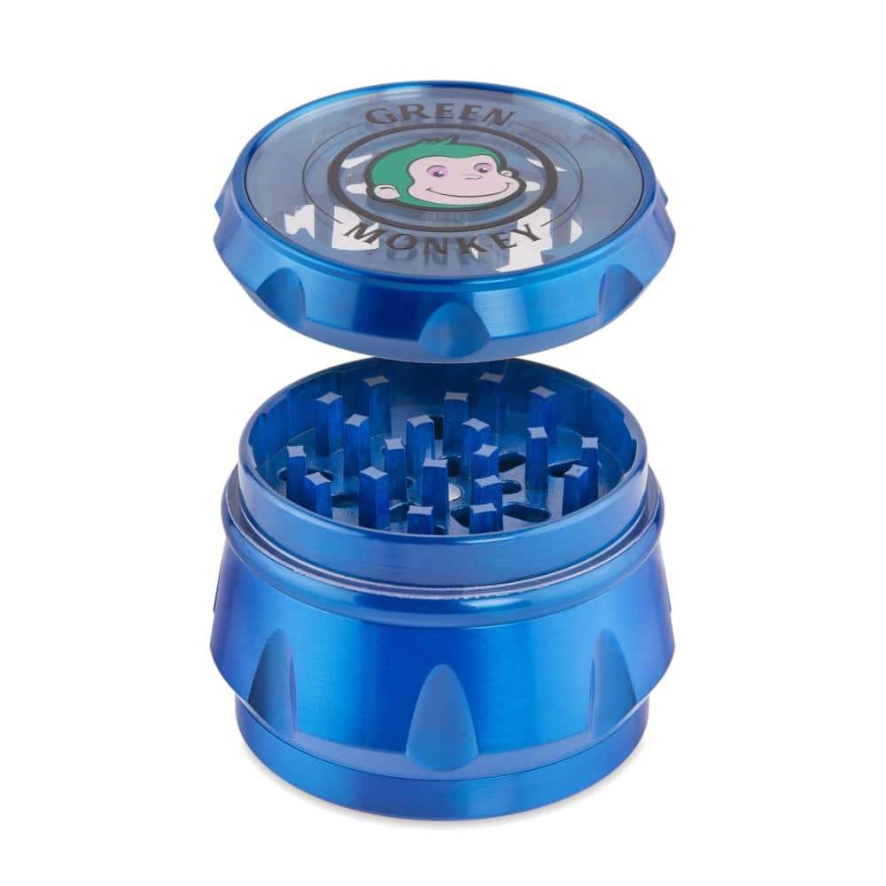 The Baboon Crown 63mm Grinder is shown in a close-up, angled view with its metallic, multi-part construction fully visible.