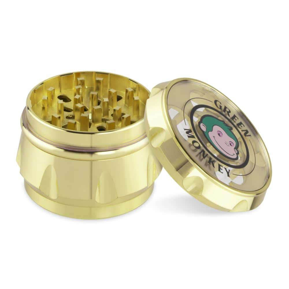 A top-down view of the open Baboon Crown 63mm Grinder, revealing its multi-tiered, gold-toned metal construction.