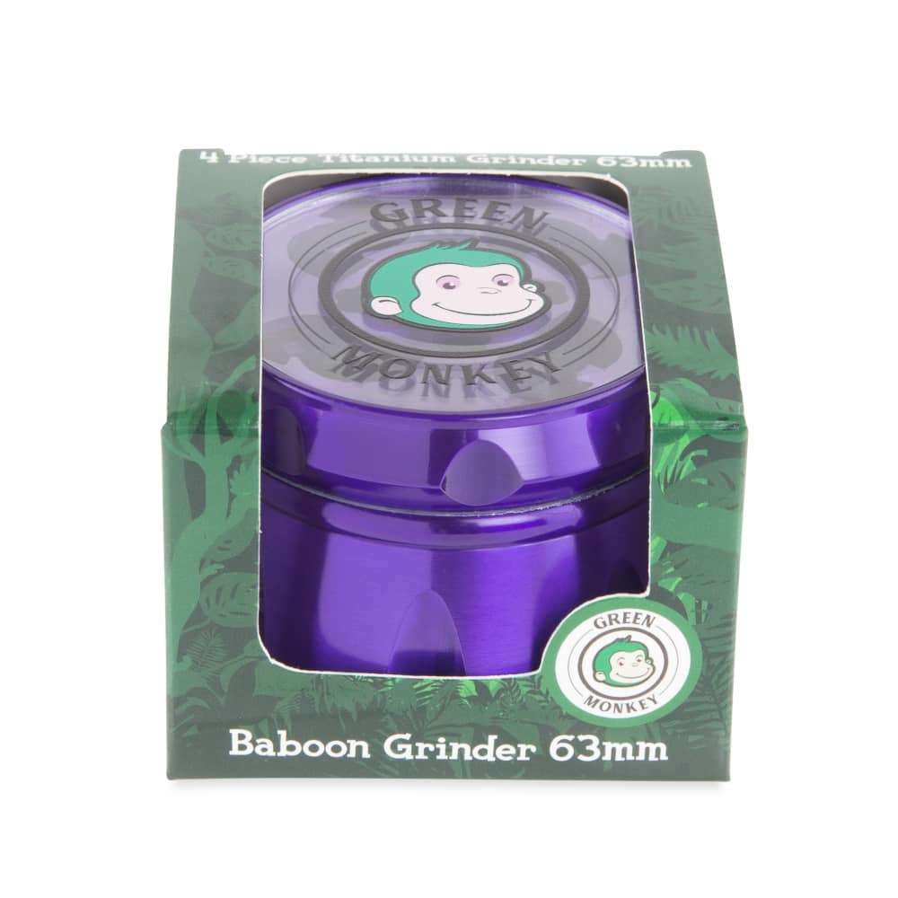 Front view of the Baboon Crown 63mm Grinder, showing the metal grinder against a dark green patterned background.