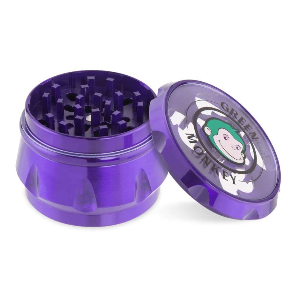 A top-down view of the open Baboon Crown 63mm Grinder, revealing the multi-tiered grinding teeth inside the metallic purple device.
