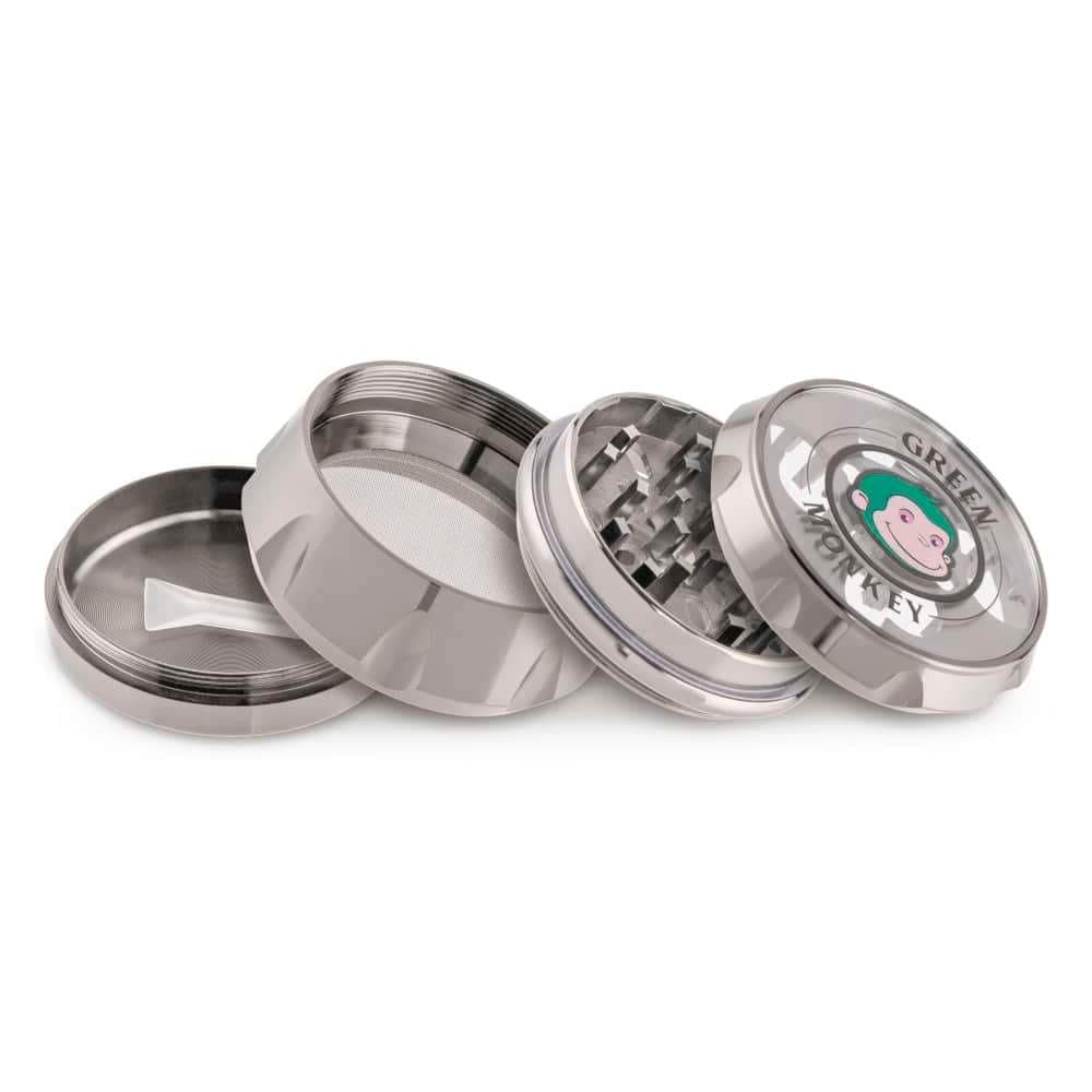 A top-down view of the disassembled Baboon Crown 63mm Grinder, showing its metallic components and textured grinding surfaces.