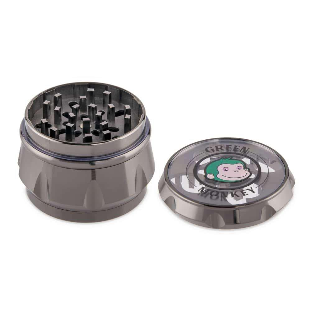 A top-down view of the open Baboon Crown 63mm Grinder, showcasing the metallic grinding teeth inside the silver and black device.