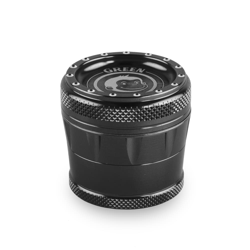 Close-up of the Tamarin 50mm Grinder, a dark metal cylindrical device with visible teeth on the top tier.