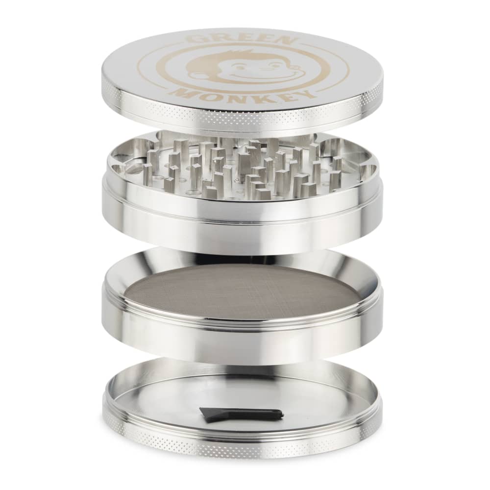 A detailed studio shot of the disassembled Capuchin 100mm Grinder, showcasing its metallic components arranged in a circular stack.