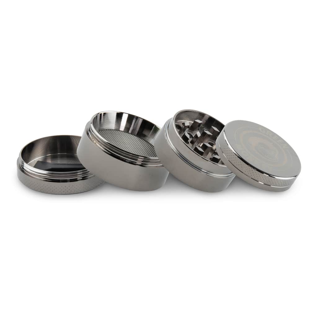 A disassembled view of the Capuchin 40mm Grinder, showcasing its metallic components arranged in a row on a neutral surface.