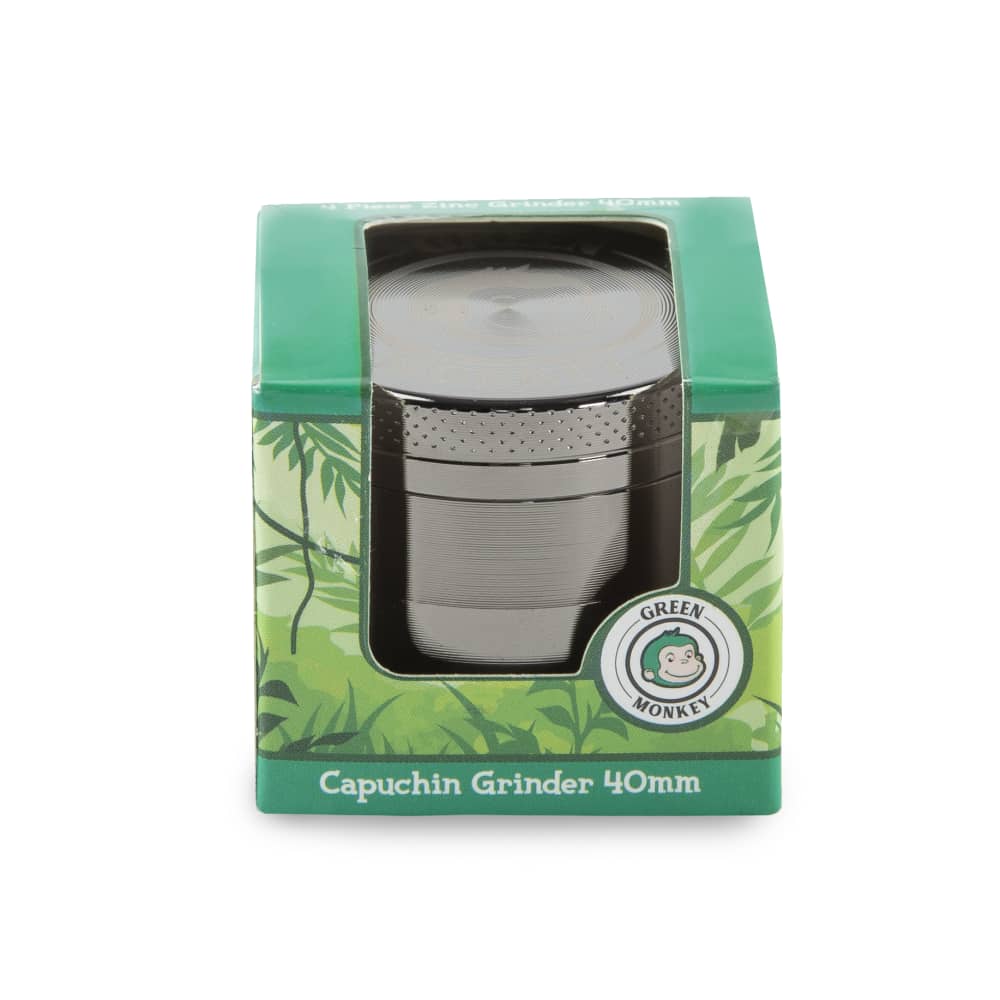 Front view of the Capuchin 40mm Grinder, showing a silver metallic grinder against a blurred green background.