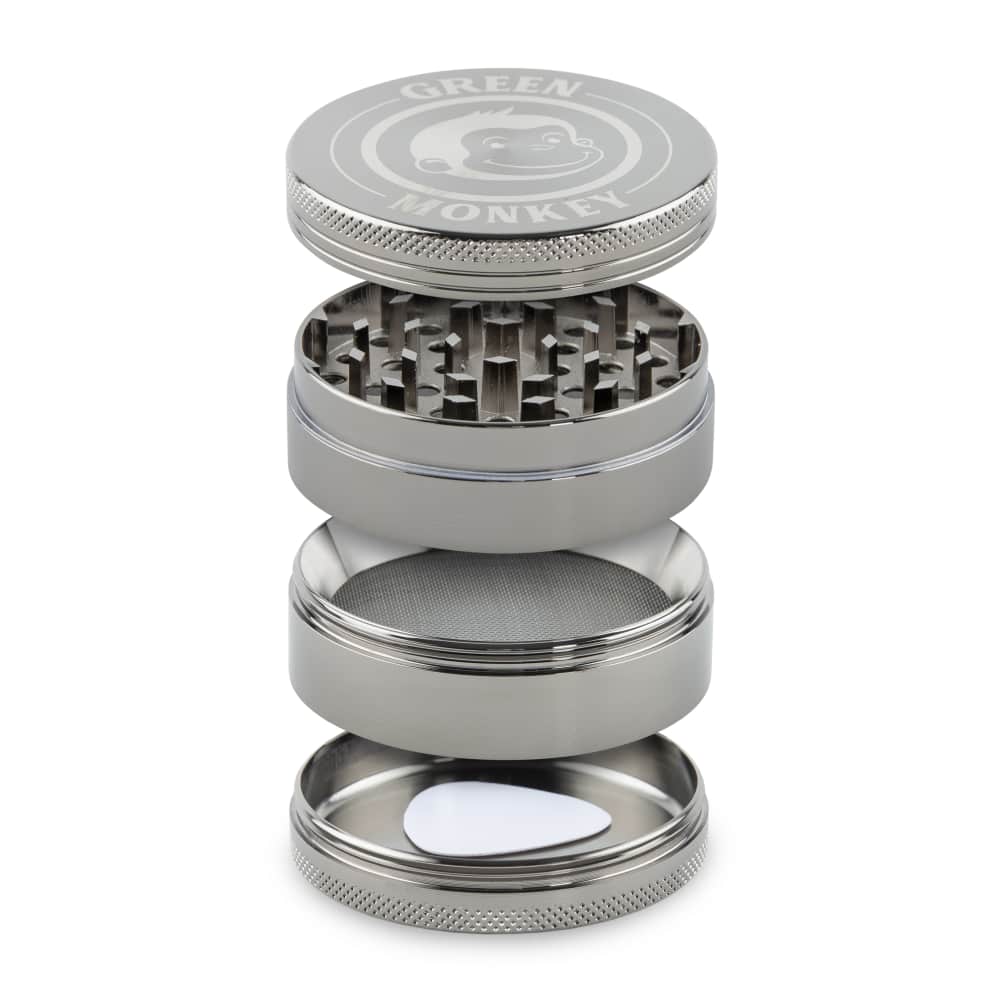 Close-up of the Capuchin 63mm Grinder disassembled, showing its stacked metal components in a bright studio shot.