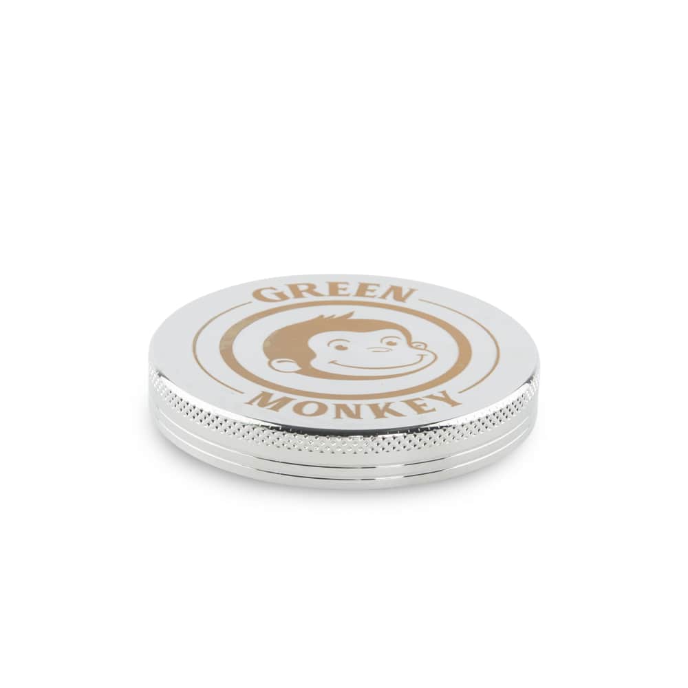 Close-up of the Capuchin 63mm Grinder with a brushed metal finish, viewed from above.