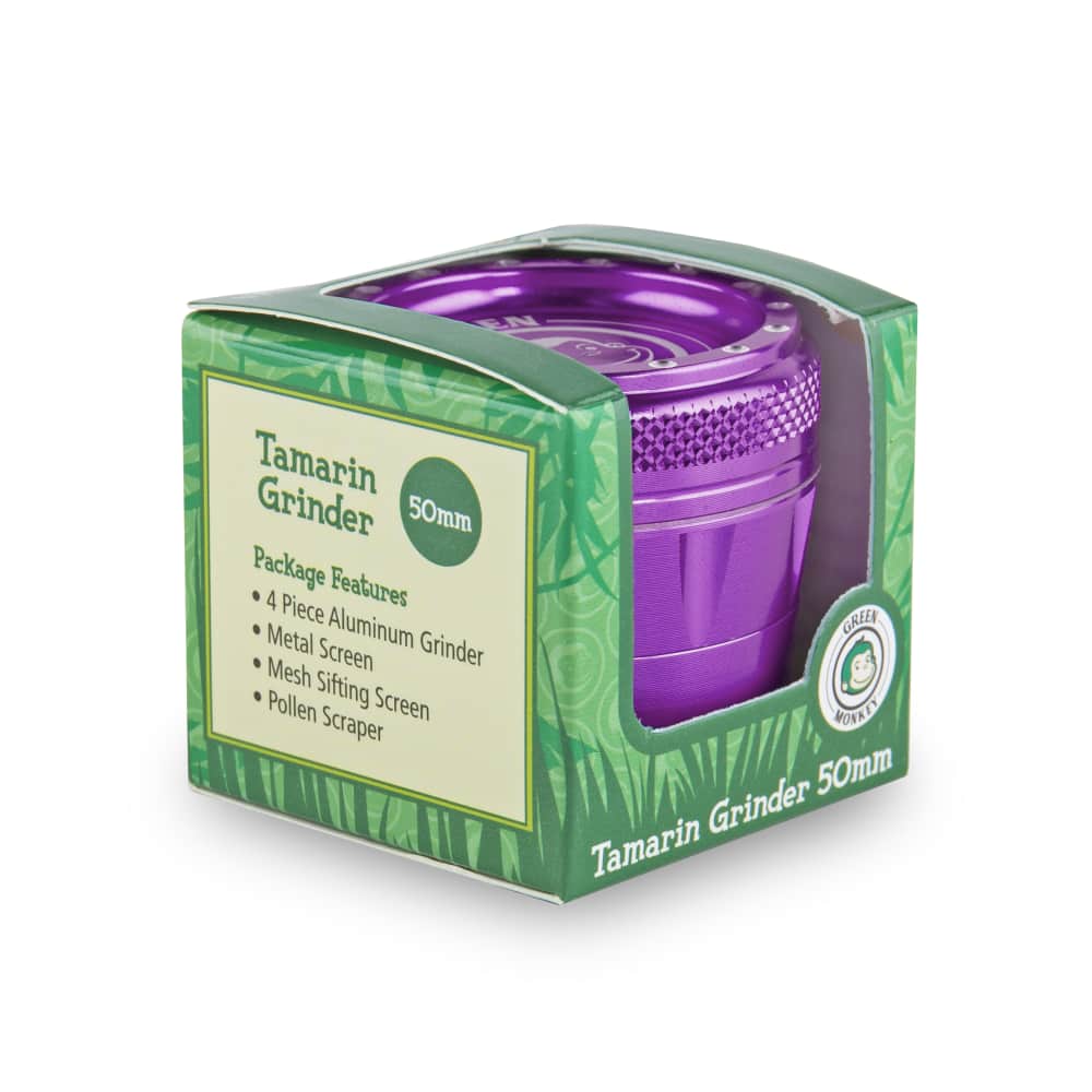 Front view of the Tamarin 50mm Grinder on a dark background, highlighting its metallic finish and compact size.