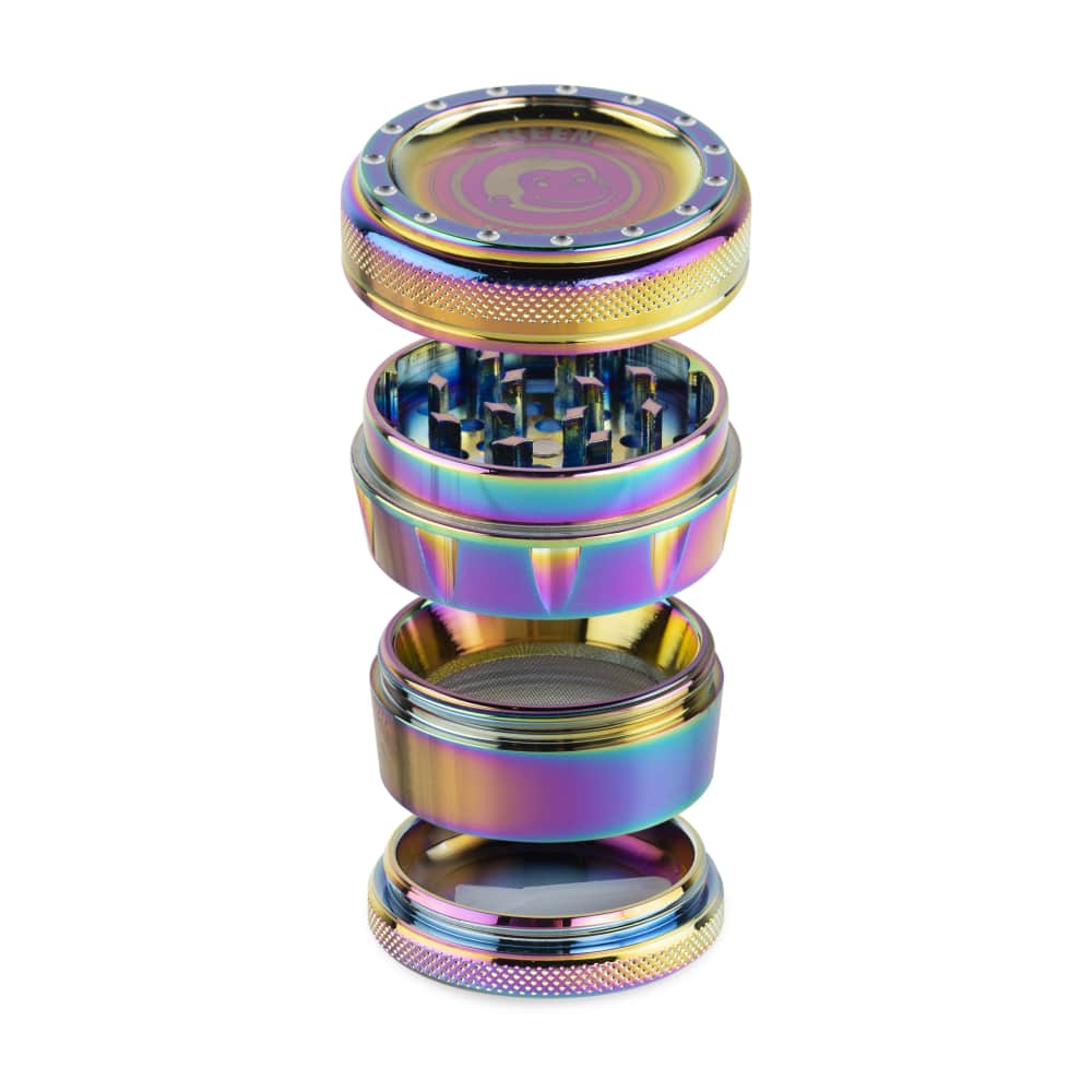 A close-up, angled view of the Tamarin 50mm Grinder, showcasing its metallic layers and disassembled components on a white background.