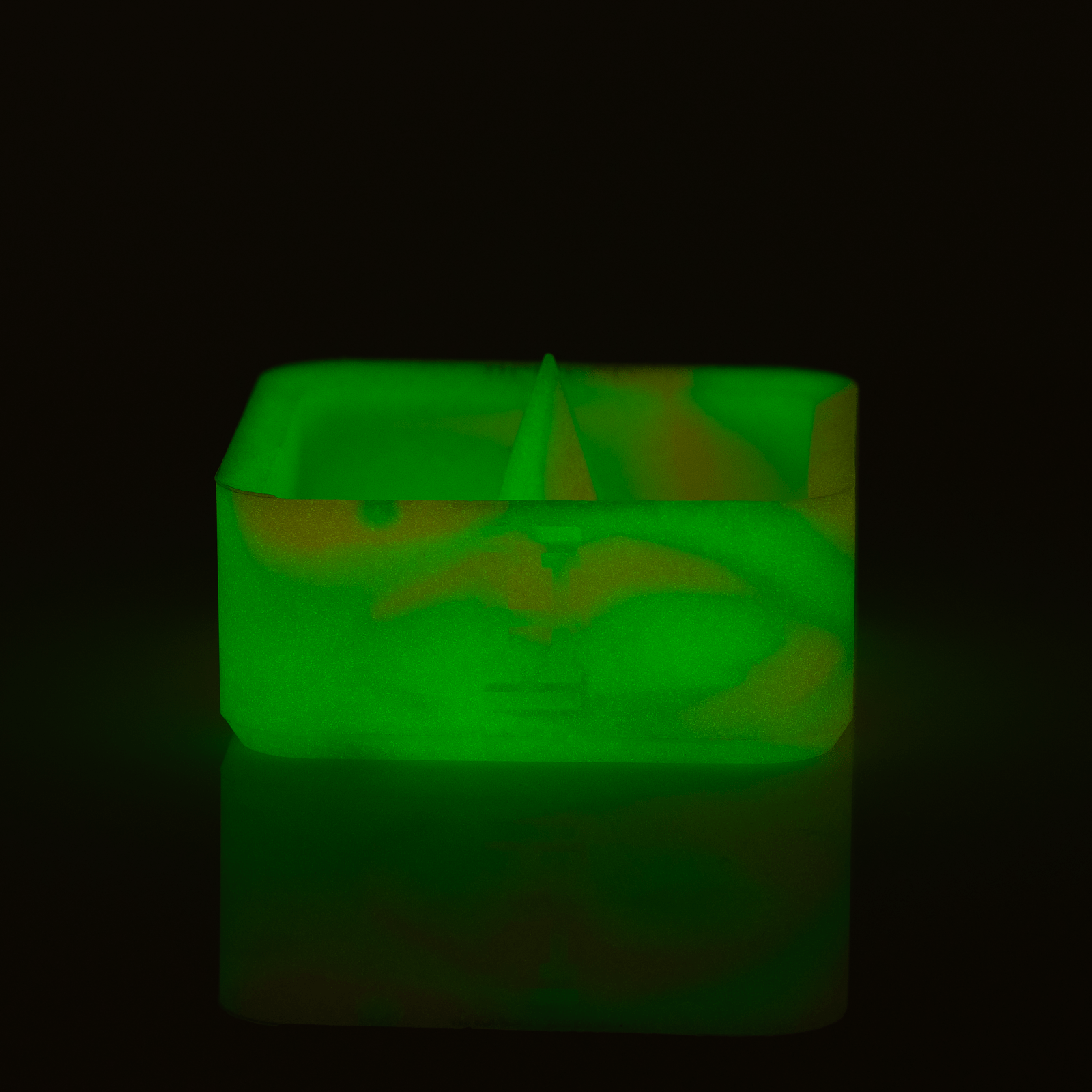 Top-down view of the Silicone Caché Debowling Ashtray, a rounded, dark-colored dish with a slight indentation.