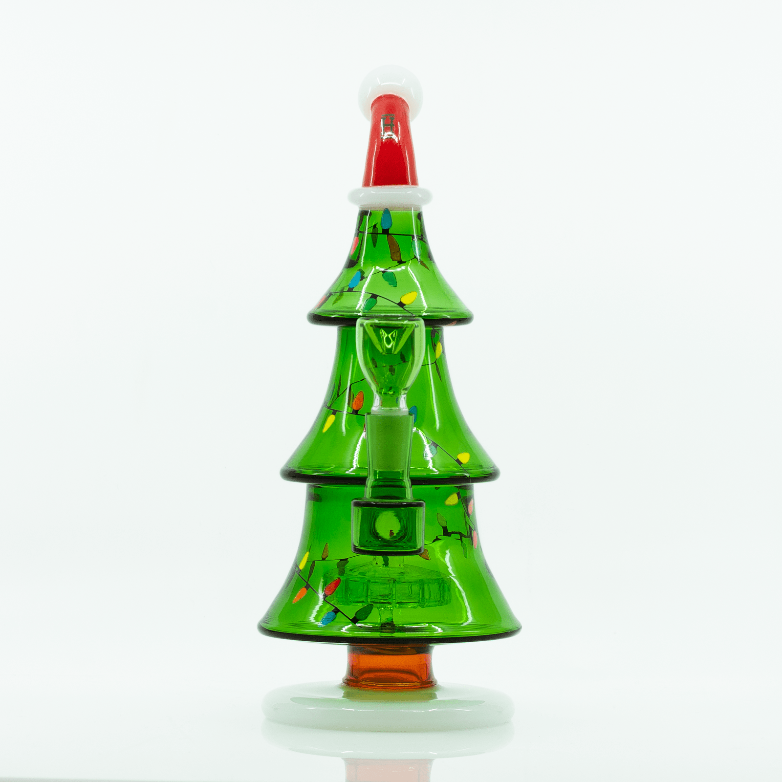 Centered front view of the Christmas Tree XL Bong, a green glass tree with tiered branches, painted multicolor lights, and a red top on a white background