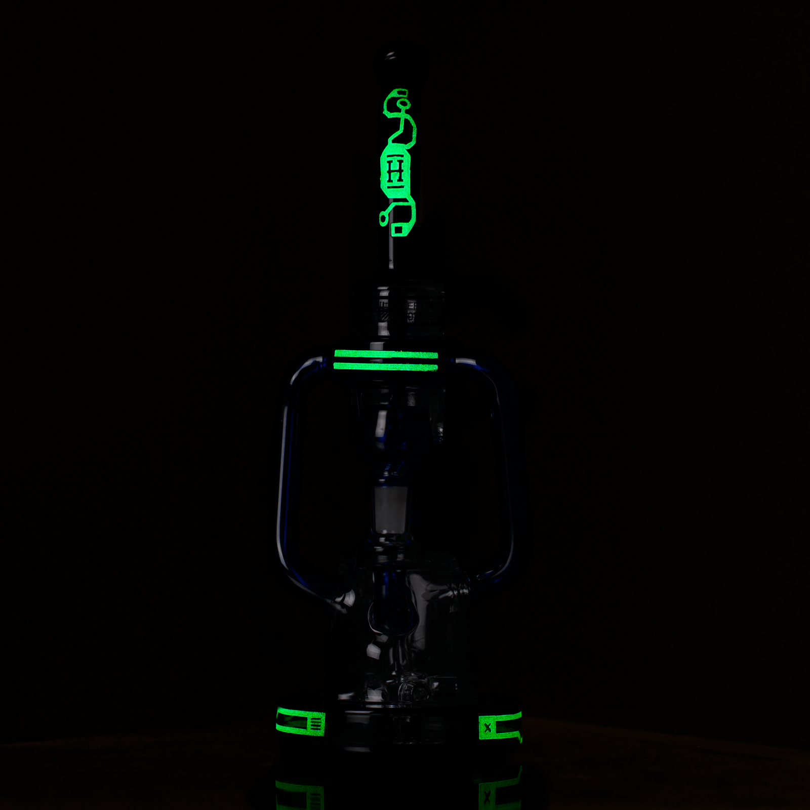 Dark studio shot of the Hemper Cyberpunk XL Recycler Bong with neon green glow accents running down its central stem and base.
