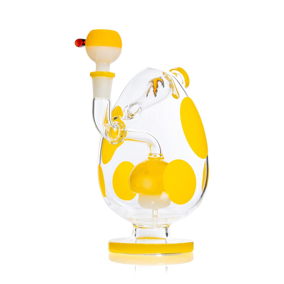 Side view of the Hemper Spotted Egg XL Bong showing a clear egg-shaped body with large yellow polka dots and a matching yellow-accented mouthpiece and base