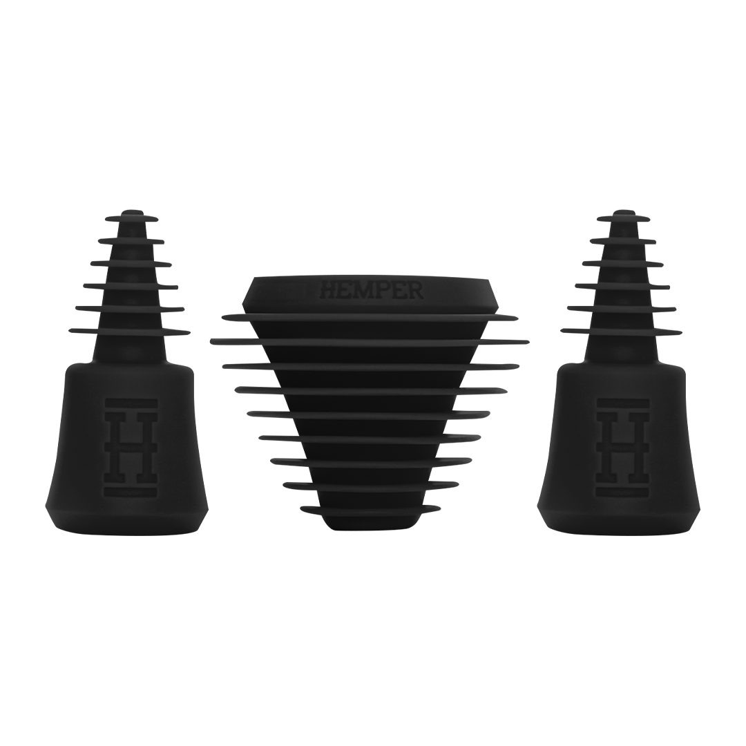 A straight-on view of the HEMBER Tech Cleaning Plugs+Caps, showing the black rubber plugs and caps arranged together.