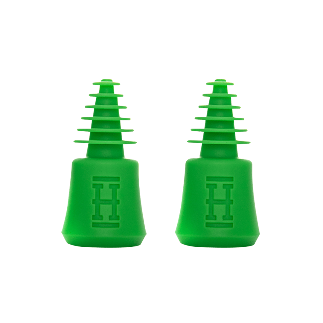 A close-up studio shot of the HEMPTER Tech Cleaning Plugs+Caps, showcasing their smooth, dark-colored silicone construction.