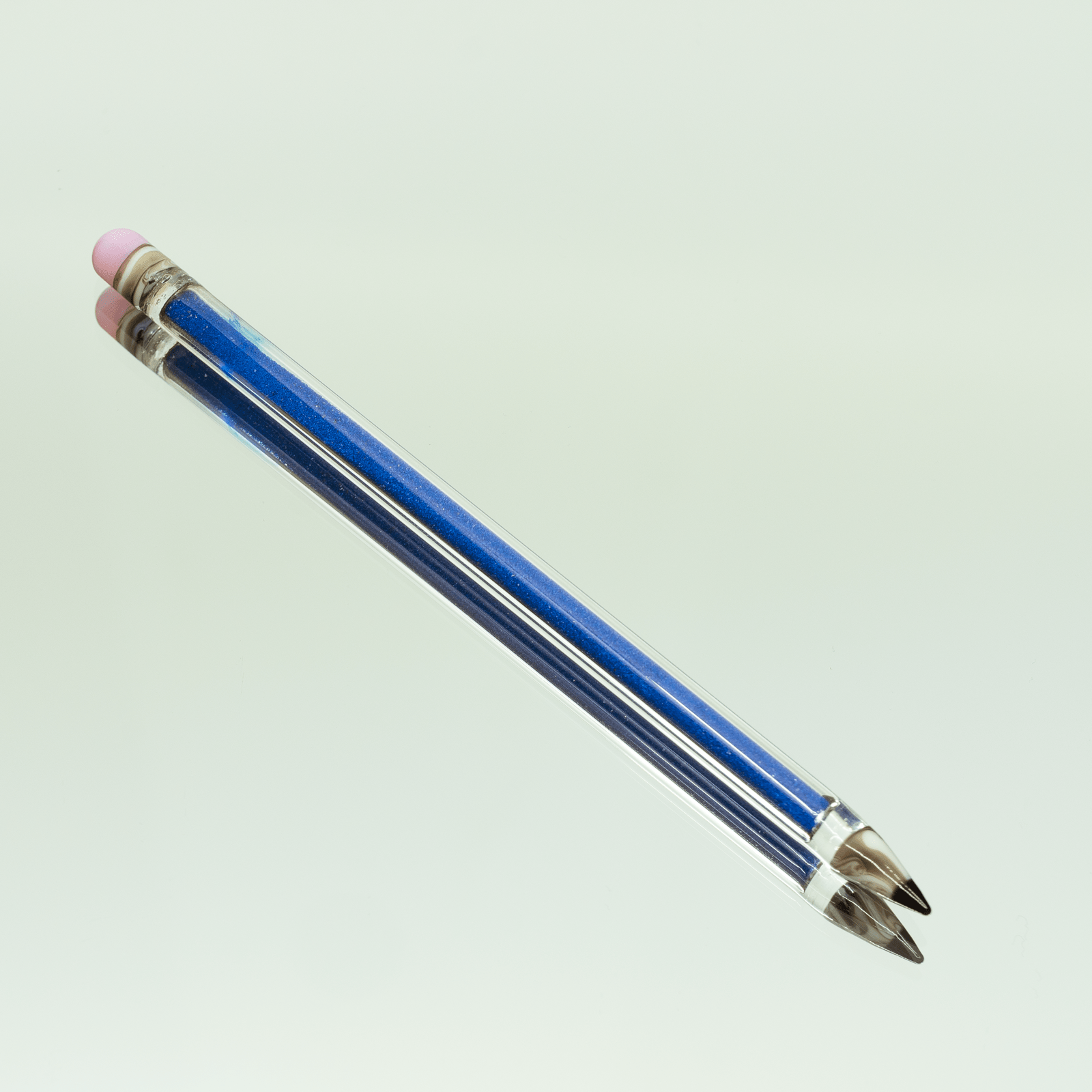 A diagonal close-up view of the Glitter Pencil Dab Tool, showcasing its clear construction and pointed tip.