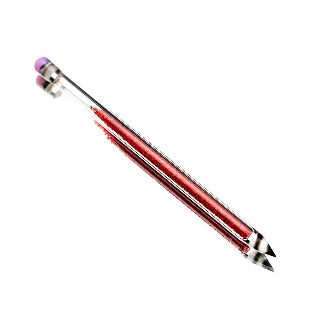 A close-up, angled view of the Glitter Pencil Dab Tool, featuring a slender, metallic body.
