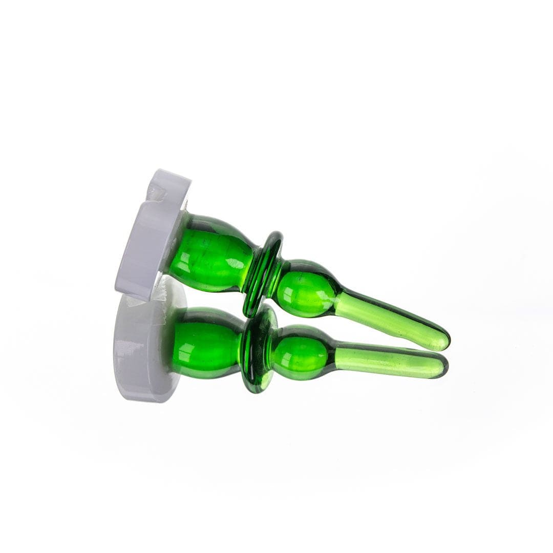 A slightly angled, close-up view of The Bishop Directional Carb Cap + Dab Tool, showcasing the green glass components against a plain white background.