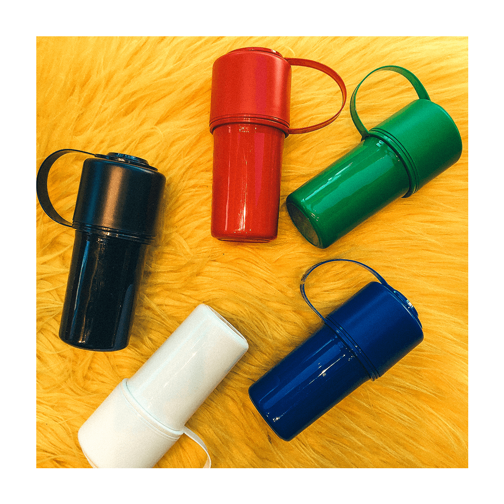 A colorful arrangement of The Keeper™ By Hemper protective cases against a textured yellow backdrop, viewed from a slight top angle.