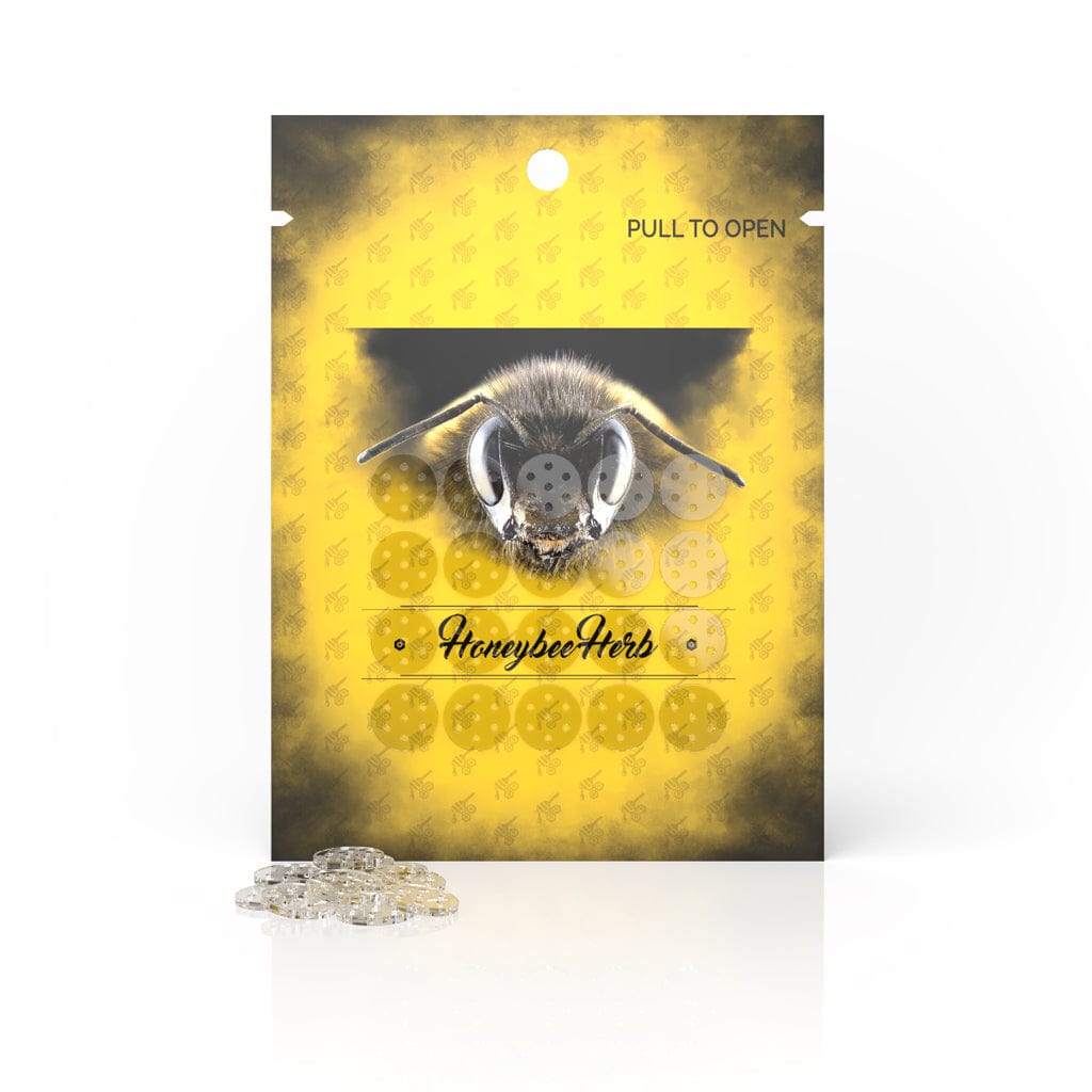 Front view of the yellow Honeycomb Flower Bowl Pipe Screens 20PK package with a bee graphic and a small pile of clear round screens in front