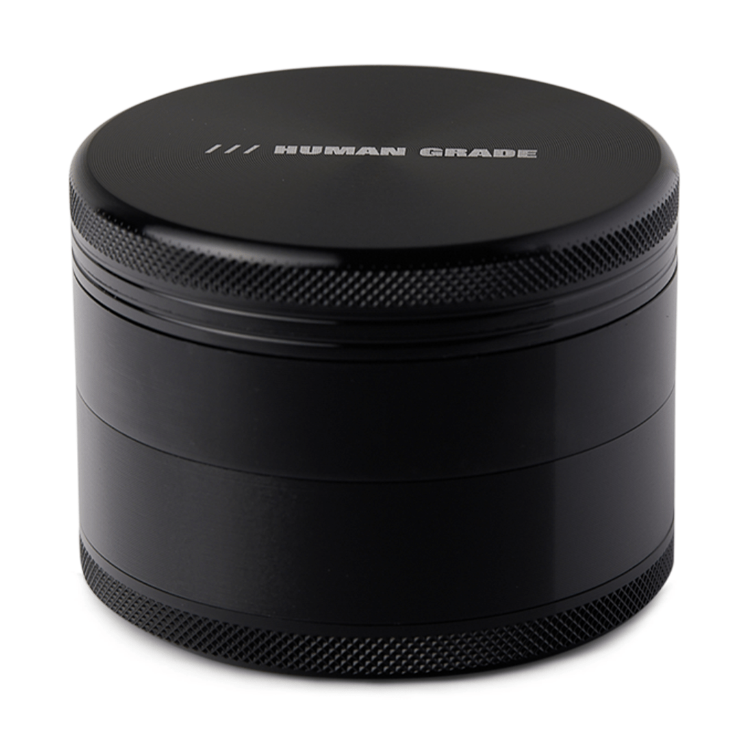Front view of the Human Grade Grinder 1B (2.5”), a sleek, cylindrical grinder with a textured metallic finish.
