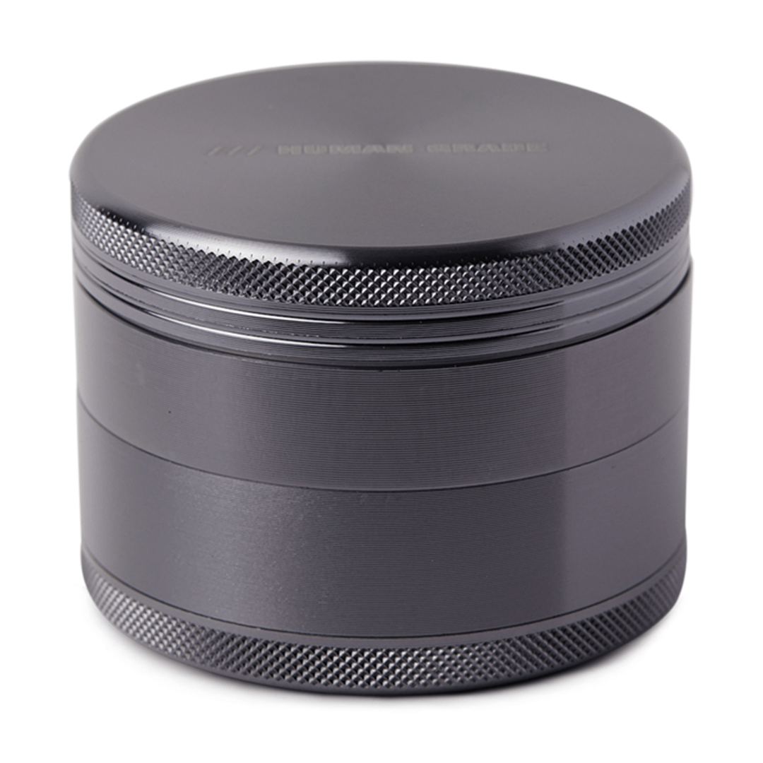 Front view of the Human Grade Grinder 1B (2.5”), a silver metal grinder with a textured surface and a cylindrical shape.