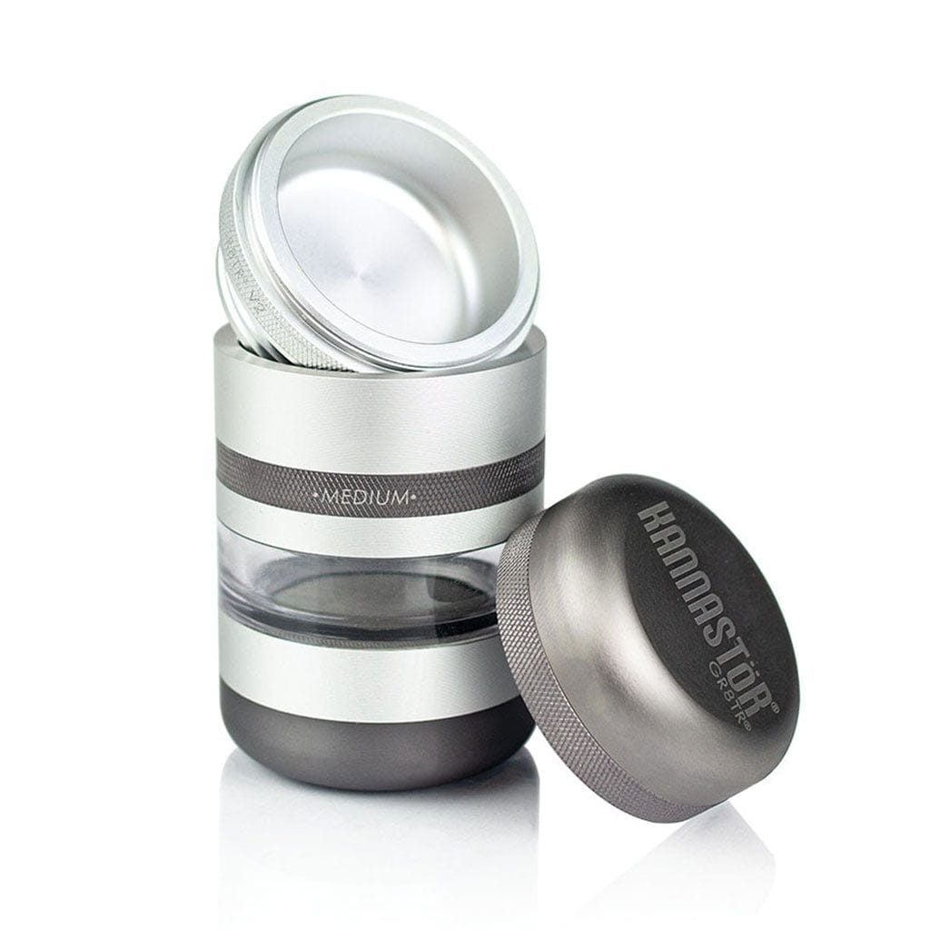Three-quarter view of a disassembled silver Ryot Gr8Tr Jar Body Grinder with its lid resting beside the stacked clear and metal body.