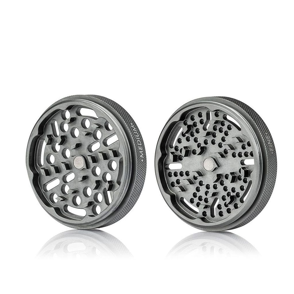Two-piece top-down view of the metallic Ryot Gr8Tr Jar Body Grinder showing textured edges and patterned grinding plates.