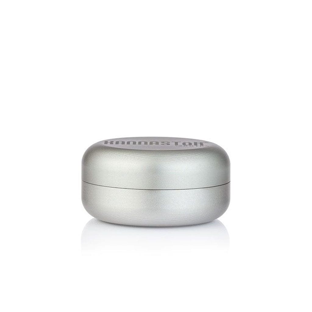 Front-facing view of the silver Ryot Gr8Tr Jar Body Grinder resting on a reflective white surface under soft, even lighting