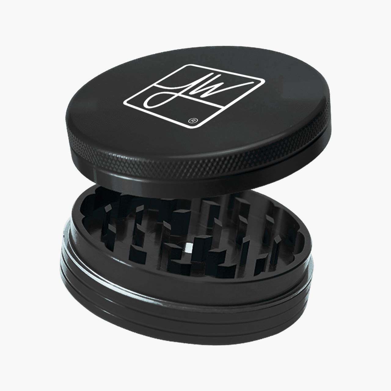 Angled close-up of a black Jane West Logo Grinder with its lid lifted to show internal teeth and a white logo on top.
