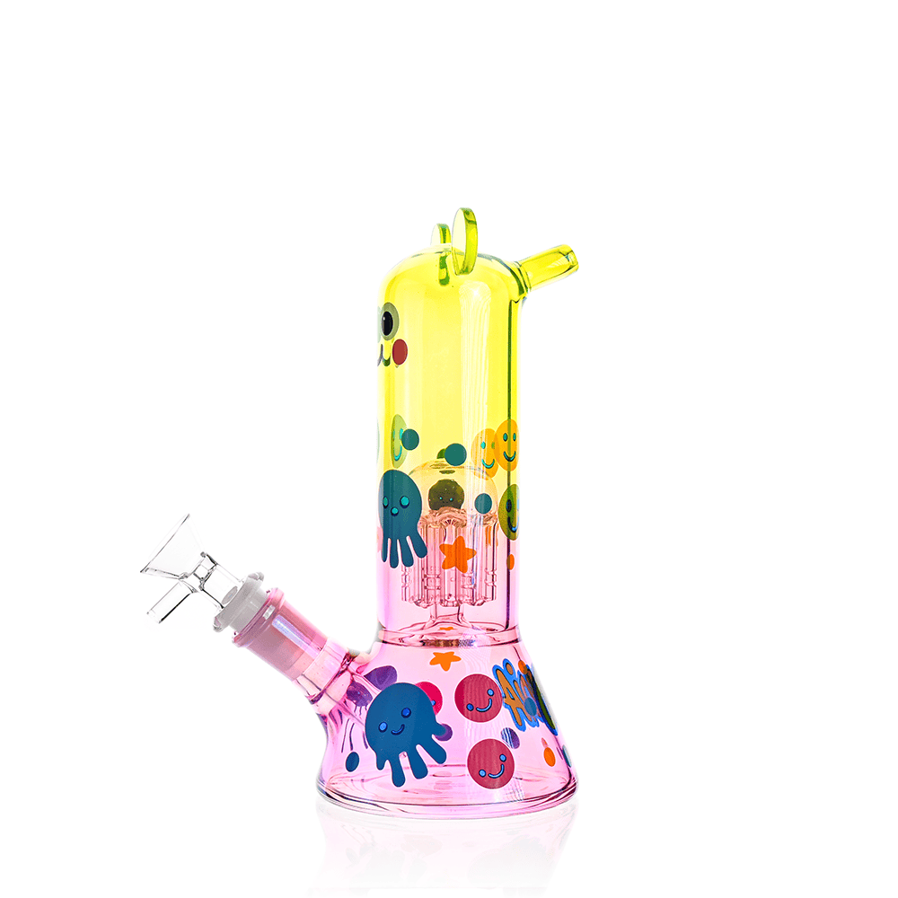 Bright studio front view of the Croia Glass Cute Character Beaker Bong with Jellyfish Design showing a yellow-to-pink glass body decorated with smiling jellyfish and bubble motifs.