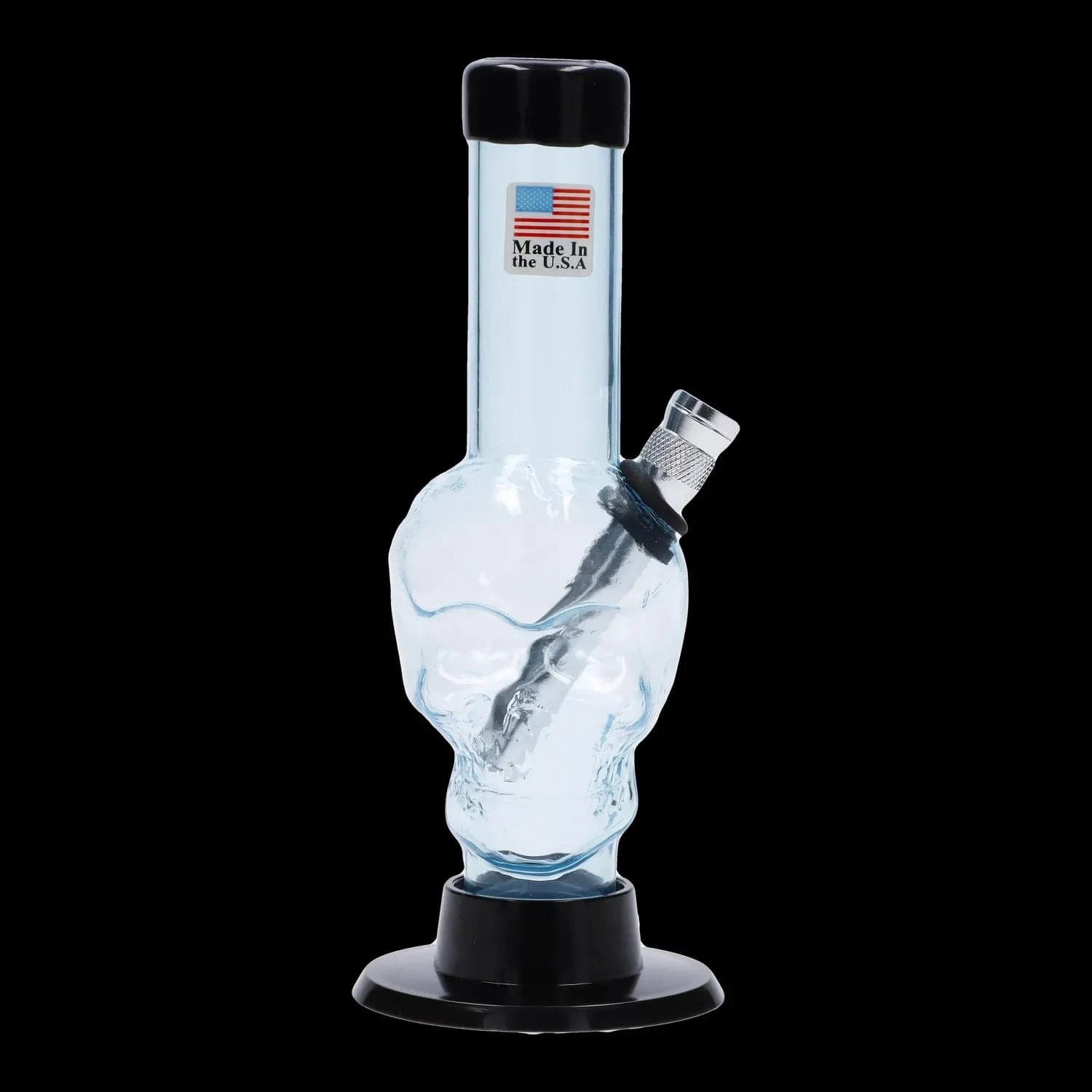 Close-up front view of the JM Plastics Mini Skull Base Acrylic Bong - 6 in. showing a light-blue skull-shaped body, angled metal bowl, and black mouthpiece against a black background
