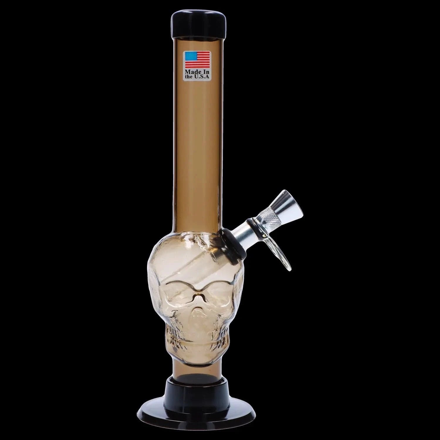 Centered front view of the JM Plastics Skull Base with Pull Slide Acrylic Bong - 8 in., showing a frosted-clear skull chamber, straight amber neck with a small American flag sticker, and a black base against a black background