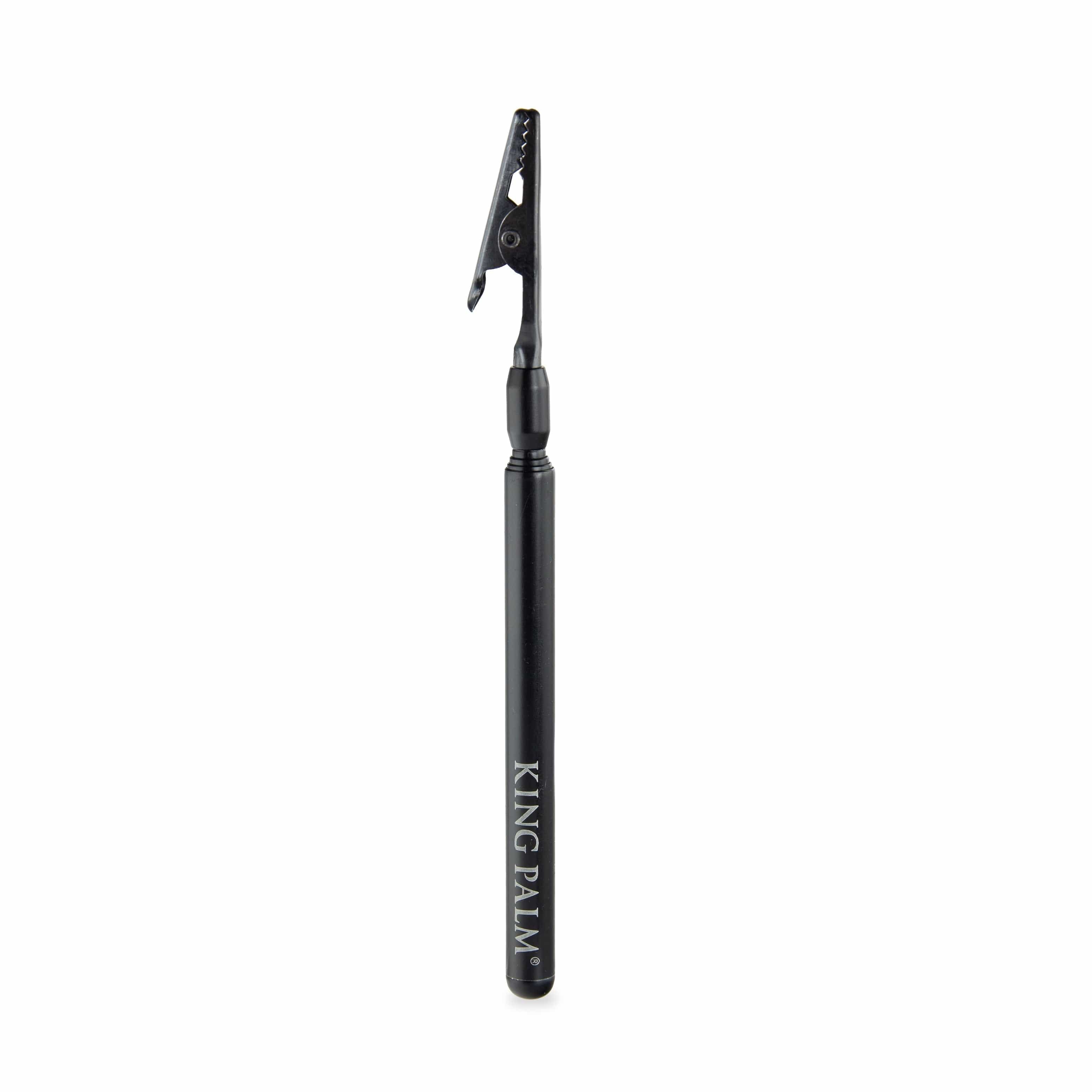 A centered, close-up view of the King Palm Roach Clip, a sleek, dark-colored metal clip with a simple design.