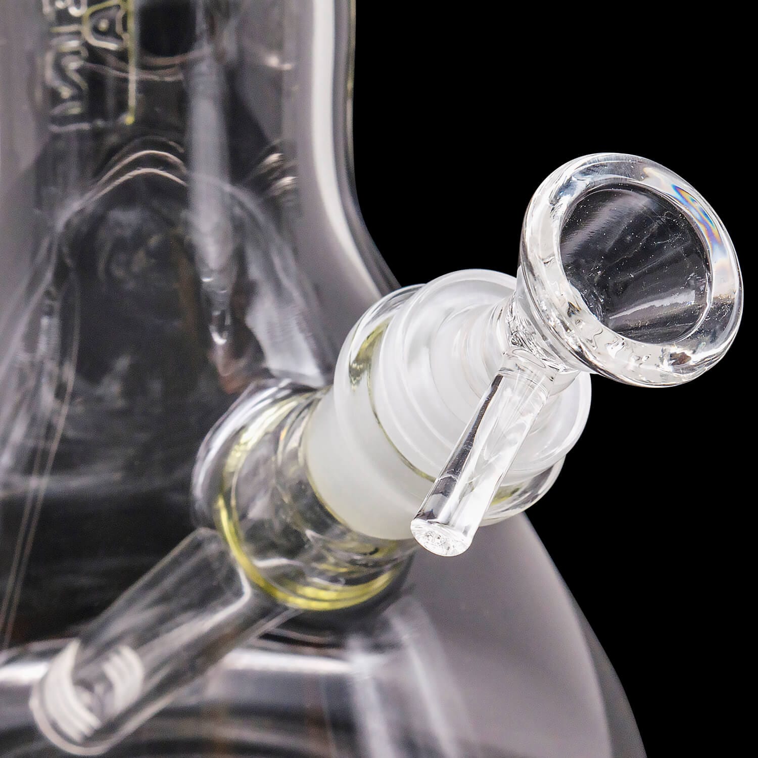 Close-up angled view of the clear glass "Magnum Flow" Thick Glass Beaker Showerhead Perc Bong joint and downstem against a black background
