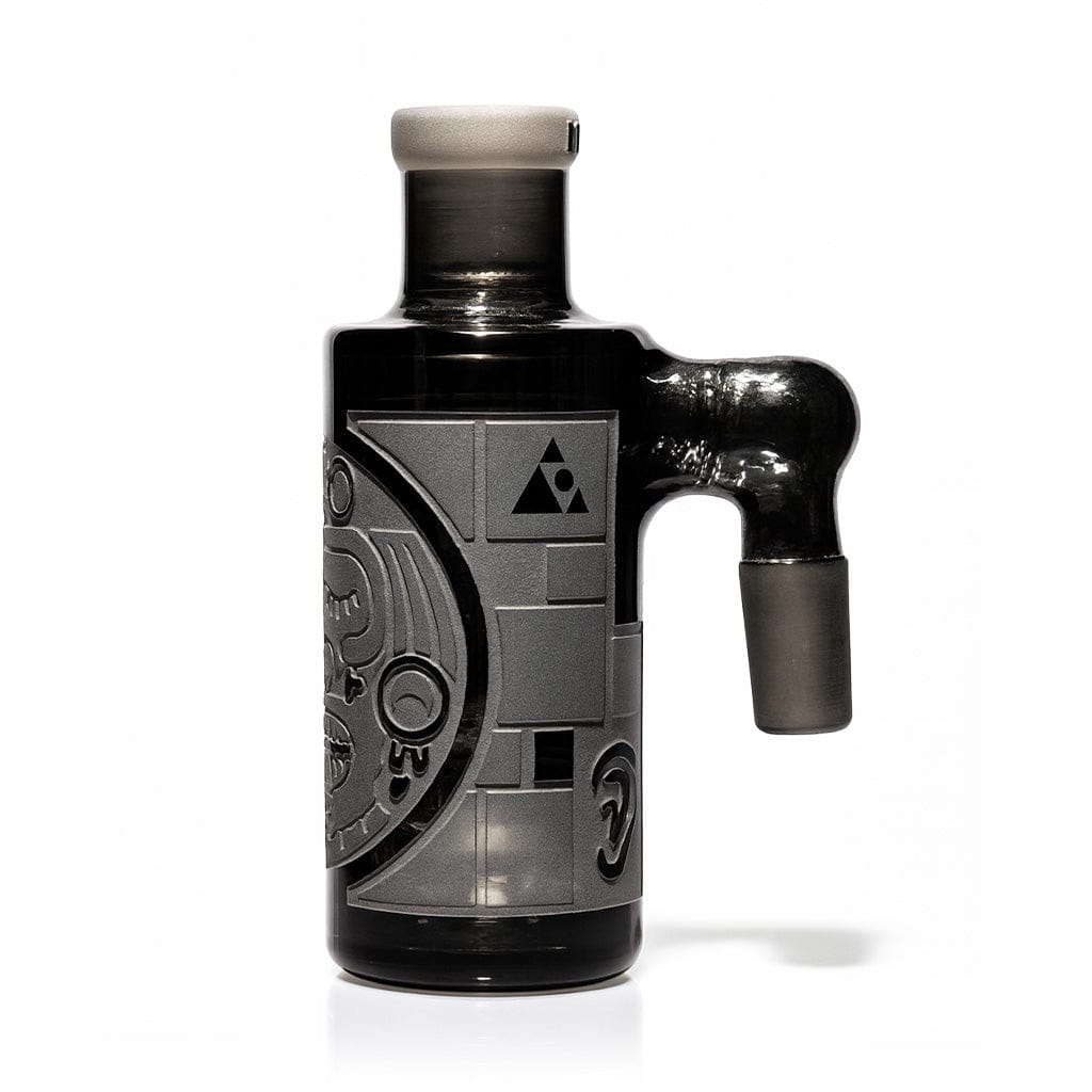 Studio-shot front view of the Milkyway Maya Wet Ash Catcher showing its matte black glass body with carved Mayan-style relief and right-side joint.