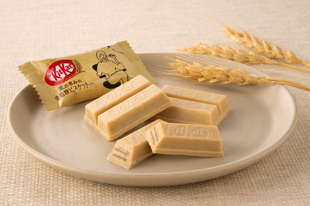 A high-angle shot of miniature Japanese KitKat Mini - Whole Wheat Biscuit pieces arranged on a light-colored surface.