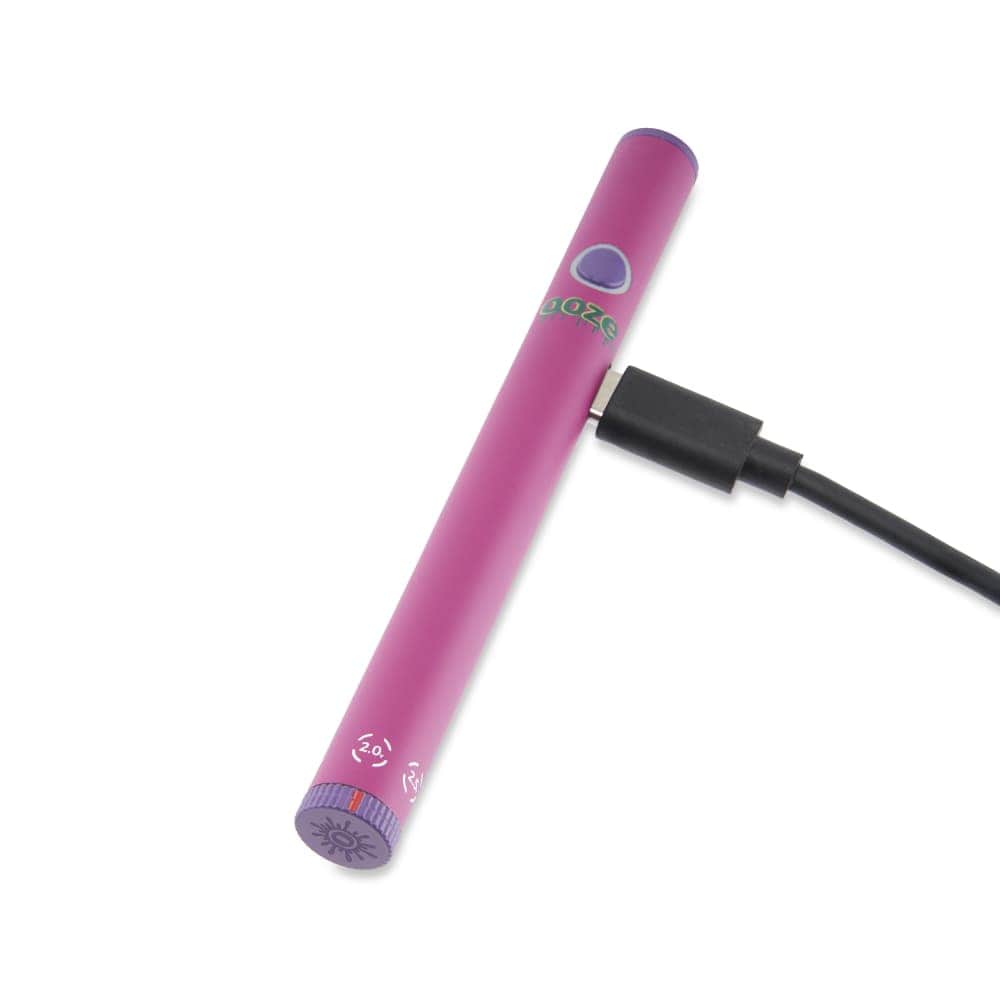 A slightly angled view of the Twist Slim Pen 2.0 510 Thread Vaporizer Battery with a USB charging cable attached.