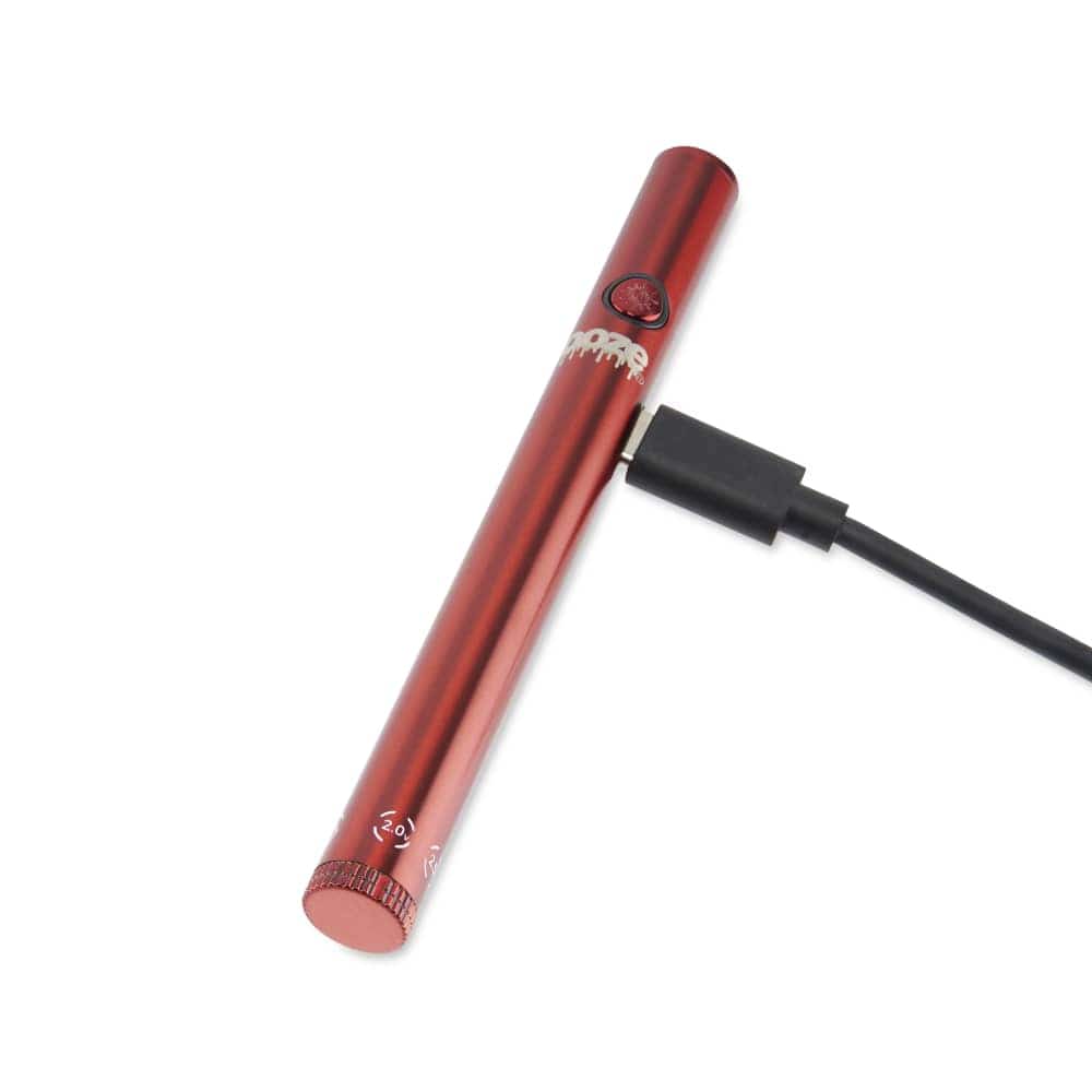 A close-up, angled view of the Twist Slim Pen 2.0 510 Thread Vaporizer Battery, showing its metallic finish and charging cable connection.