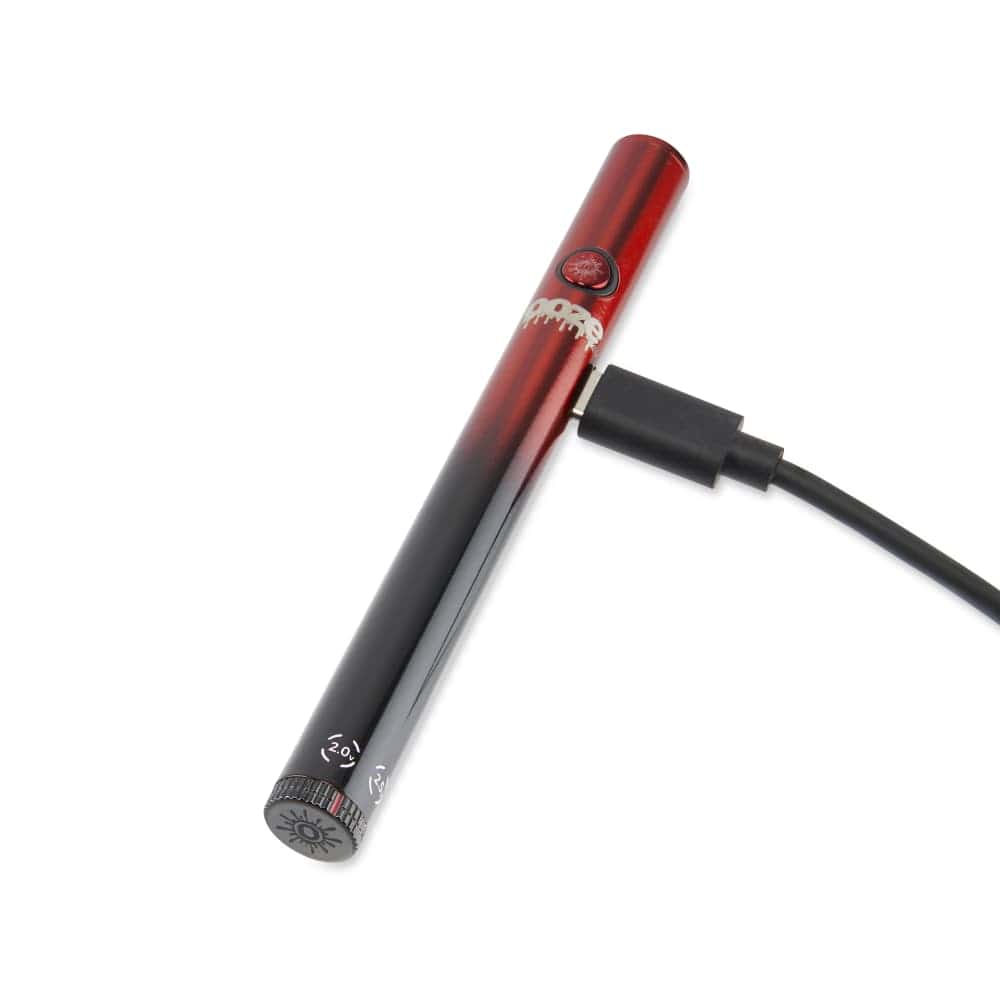 A close-up of the Twist Slim Pen 2.0 510 Thread Vaporizer Battery, showing its sleek silver finish and charging cable connection.