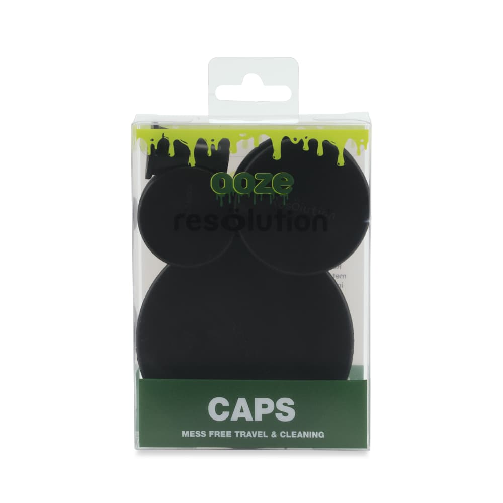 Front-facing shot of a clear blister pack showing three black round Ooze Resolution Caps against a white background with green branding at the top.