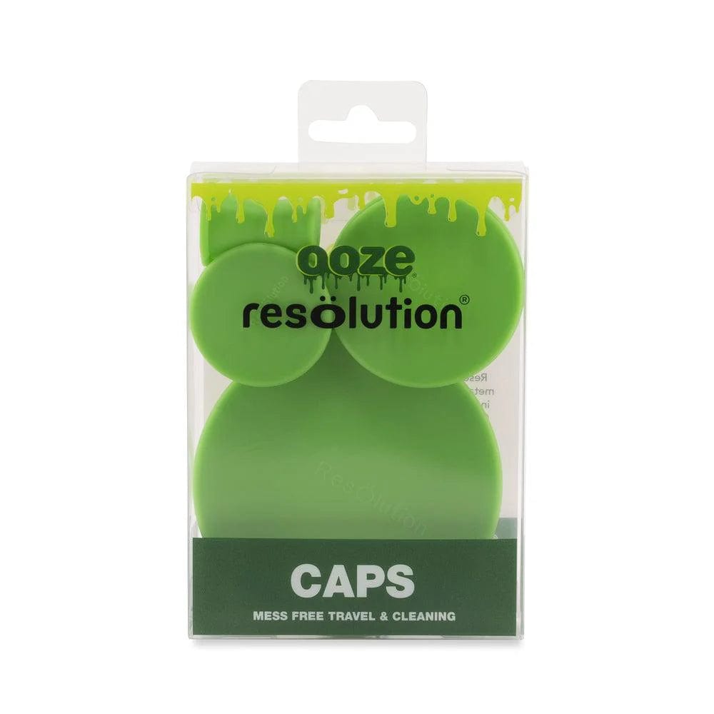 Front view of bright green Ooze Resolution Caps in clear retail packaging with drip graphic and "CAPS" label at the bottom