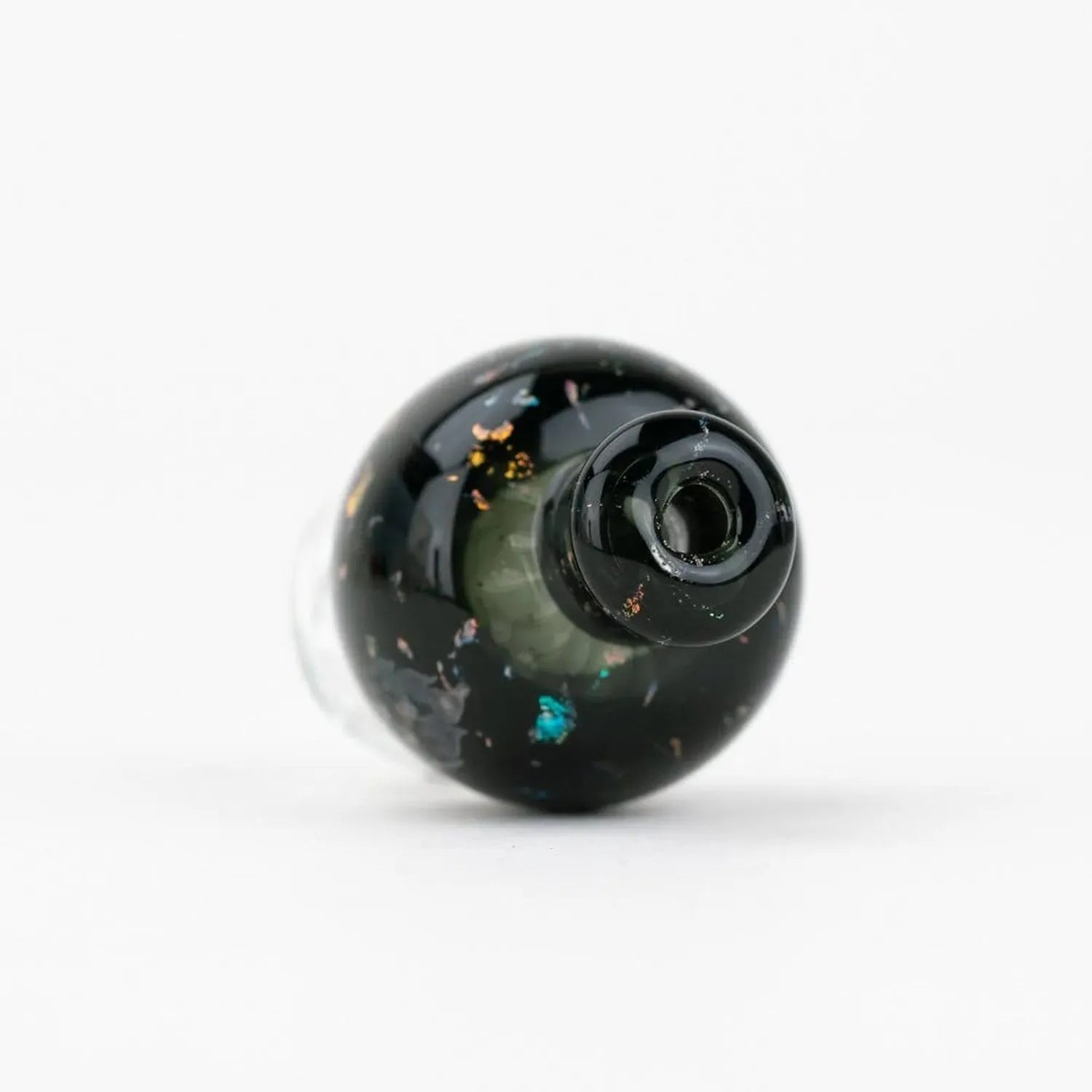 Top-down close-up of the black, flecked Empire Glassworks Puffco Pivot Glass Mouthpiece - Black Nebula resting on a white background.