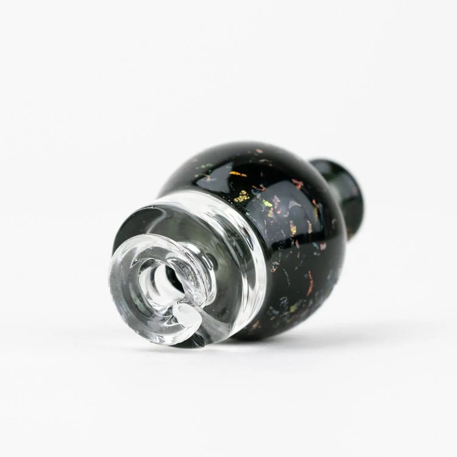 Close-up angled view of the Empire Glassworks Puffco Pivot Glass Mouthpiece - Black Nebula showing its glossy black body with iridescent flecks and clear glass tip.