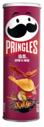 Front view of Pringles - BBQ Steak chips in a cylindrical can, showcasing a close-up of the stacked chips inside.