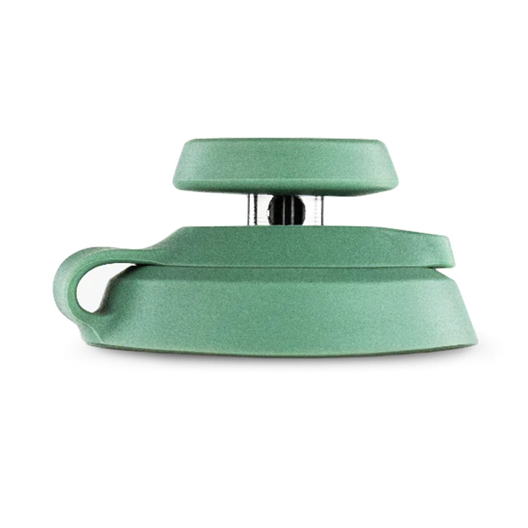 Front-facing close-up of a mint green Puffco Proxy Carb Caps showing its layered circular top and curved base against a white background